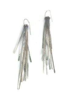 "A sleek pair of sterling silver earrings to ring in the New Year. Hand forged fringe have a shimmery and kinetic quality. The light catches the fringe in a lovely way. They are Oxidised and brushed to a dark shiny finish. The earrings are 4\" long x 1/2\"" Contemporary Silver Earrings For Evening, Contemporary Silver Evening Earrings, Silver Fringe Drop Earrings, Silver Fringe Long Drop Earrings, Modern Silver Linear Earrings For Party, Silver Long Drop Linear Earrings For Evening, Silver Long Drop Earrings For Evening, Silver Fringe Metal Earrings, Dark Silver Earrings