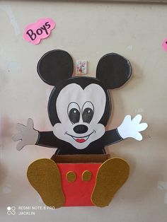 a mickey mouse cutout hanging on the wall