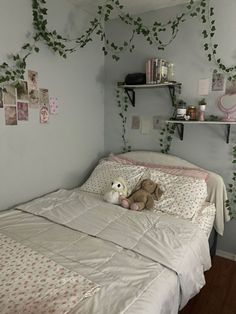 a teddy bear sitting on top of a bed in a room with ivy growing up the walls