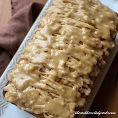 a loaf of bread covered in gravy on a plate