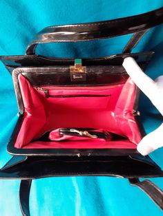 Harrods black patent leather 60s bag. Stunning pink leather interior. With matching purse. Two outer sleeves. In very good vintage condition. Two leather top handles. Real leather label. Gold tone clasp in good order. Pre loved 60s bag so it will show minor signs of use. Measures 10 inches wide. 8 deep. Formal Rectangular Bag With Lined Interior, Formal Rectangular Shoulder Bag With Lined Interior, Top Handle Bags, Leather Label, Black Patent Leather, Pink Leather, Leather Interior, Leather Top, Harrods