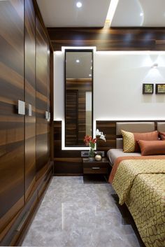 a bedroom with a bed, dresser and mirror on the wall next to each other