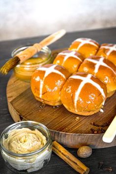 hot cross buns on a cutting board with dip