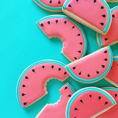 watermelon cookies are arranged on a blue surface