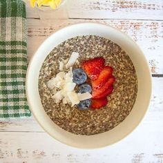 a bowl of oatmeal with strawberries and blueberries