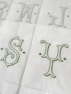 embroidered monogrammed napkins with the letters s and w in green on white paper