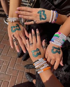 several people with tattoos on their arms and hands are holding each other's hands