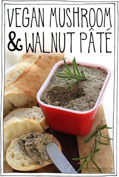 a wooden cutting board topped with bread next to a bowl of pesto and walnut pate