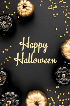 black and gold halloween decorations with the words happy halloween