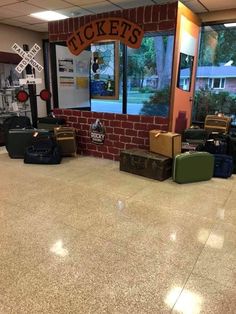 several suitcases are lined up in front of a brick wall with the words ticket's on it