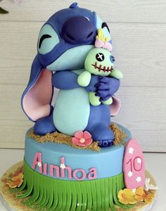 a birthday cake with an image of stitch and stitch hugging each other