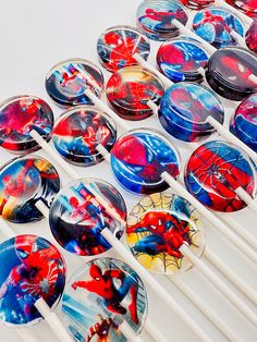 many spiderman plates are lined up on the table