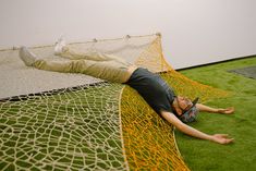 a man laying on the ground in a hammock