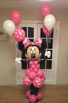 a minnie mouse balloon with pink and white balloons