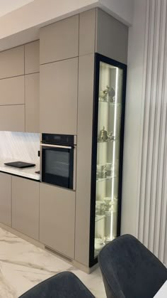 a modern kitchen with an oven, microwave and countertop area in the middle of the room