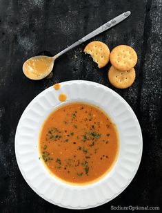 a bowl of soup with crackers on the side