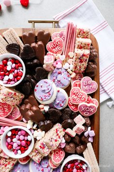 valentine's day treats are arranged on a platter with candy and marshmallows