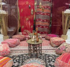 a room filled with lots of pillows and rugs