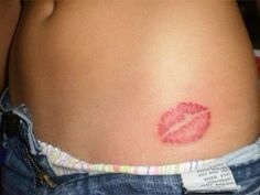 a woman's stomach with a red lipstick imprint on it