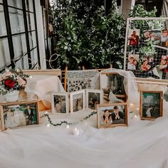 a table topped with pictures and flowers on top of it