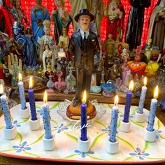 a table topped with lots of candles and figurines