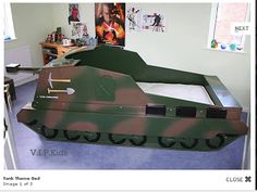 an army tank bed is on display in a room with pictures and other items around it