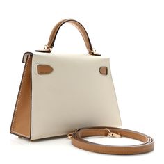 This is an authentic HERMES Epsom Horseshoe Mini Kelly Sellier 20 in Craie and Biscuit. This stunning handbag is crafted in stamped epsom calfskin leather in ivory and tan. A single rolled leather top handle is secured with gold plated hardware and an optional leather shoulder strap is included. The traditional Kelly turn lock secures the small flap. The interior features a matching chevre goatskin leather with a single flat pocket. Hermes Kelly Shoulder Bag, Hermes Crossbody Bag, Mini Kelly, Kelly Sellier, Plastic Stickers, Hermes Bags, Bag Straps, Leather Top, Top Handle