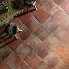 an overhead view of two stools on a tiled floor