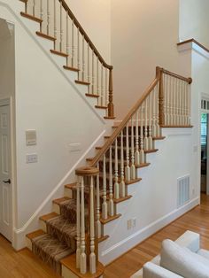 a white staircase with wooden handrails in a house