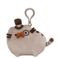 a keychain with a small animal on it's side and a hat on top