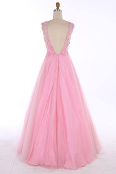 a pink dress on a mannequin dummy with an open back and beading