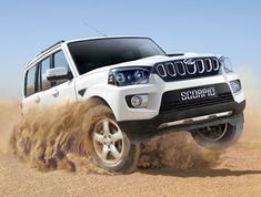 a white suv driving through dirt on top of a sandy ground with the words book an appointment