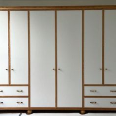 a large white and wood armoire in a room