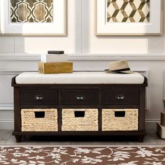 a living room with two pictures on the wall and three baskets in front of it