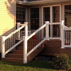 a house with white railings and windows