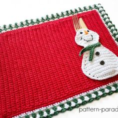 a crocheted placemat with a snowman on it