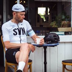 a man sitting at a table with a laptop