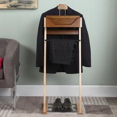 a coat rack with shoes on it next to a chair