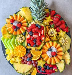 fruit platter with pineapples, oranges, strawberries, and kiwi