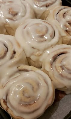 several cinnamon rolls sitting on top of a baking pan