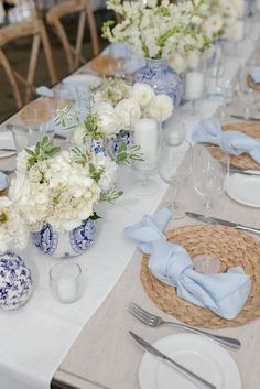 the table is set with blue and white flowers