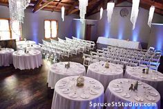 a room filled with tables and chairs covered in white tablecloths