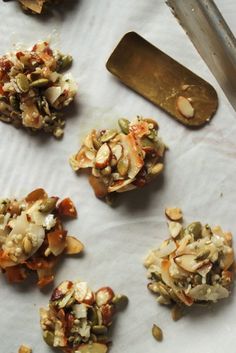 several pieces of food sitting on top of a white paper towel next to a knife