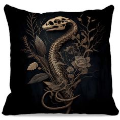 a pillow with a snake on it and flowers in the middle, against a black background