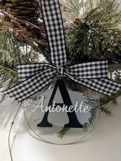 a glass ornament with the word autonetie hanging from it's side