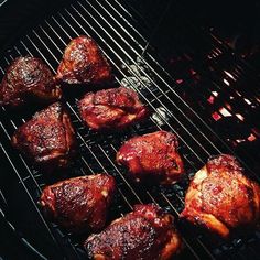 some meat is cooking on a grill in the evening time, and it looks like they are going to be grilled