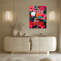 a living room with white furniture and flowers on the sideboard in front of it