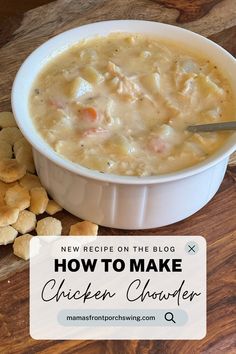 a white bowl filled with chicken chowder next to crackers on a wooden table