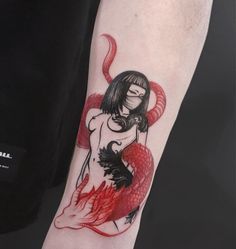 a person with a red and black tattoo on their arm