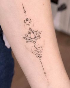 a woman's arm with a tattoo on it that reads, love and lotus